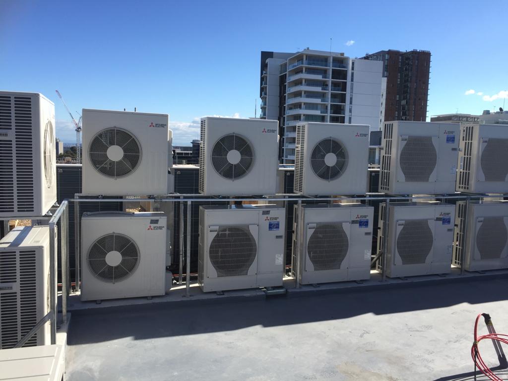 Two rows of Mitsubishi Air conditioner machines mounted on rooftop